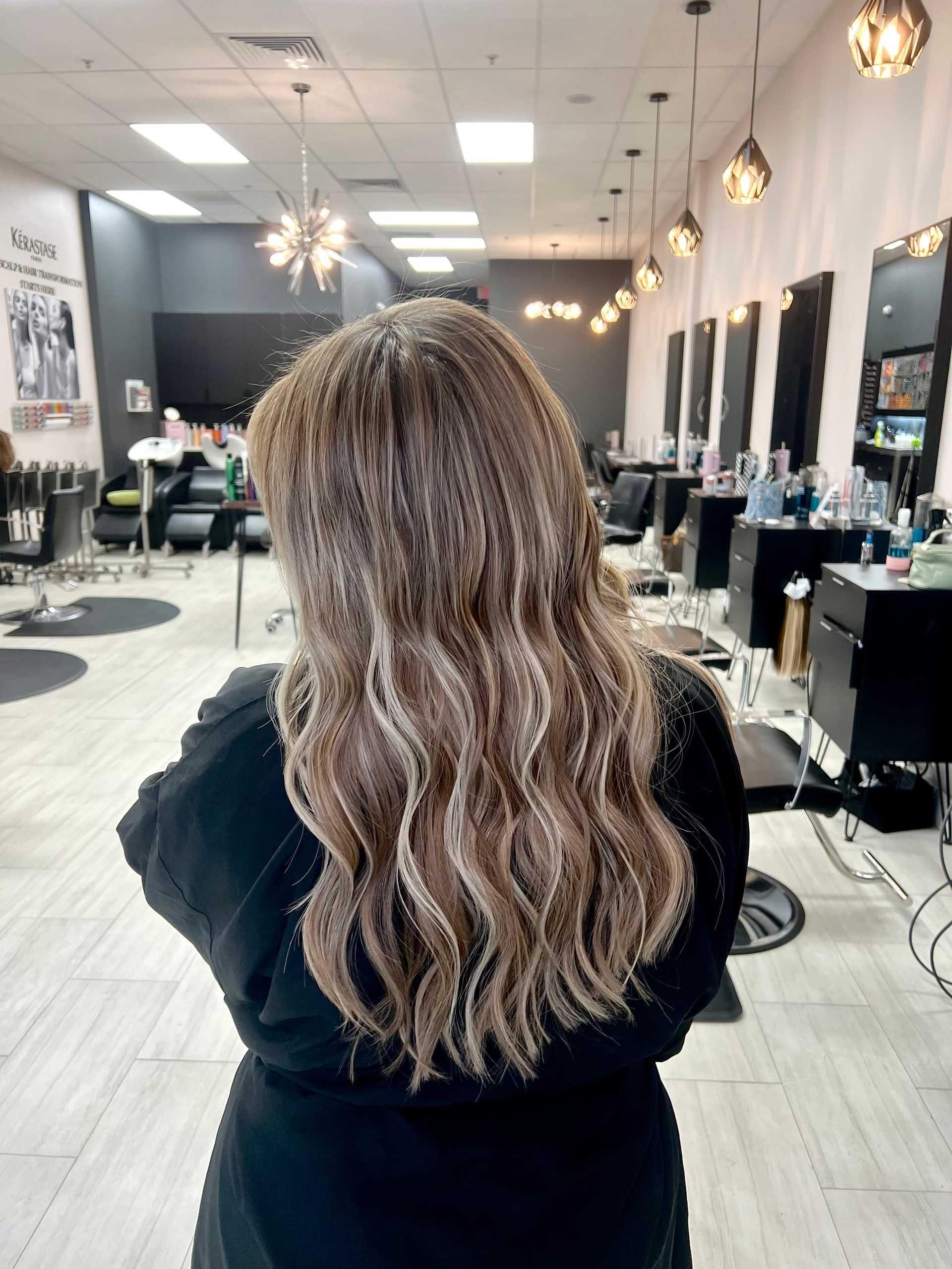 Long, dimensional blonde hair with natural-looking extensions for added length and volume