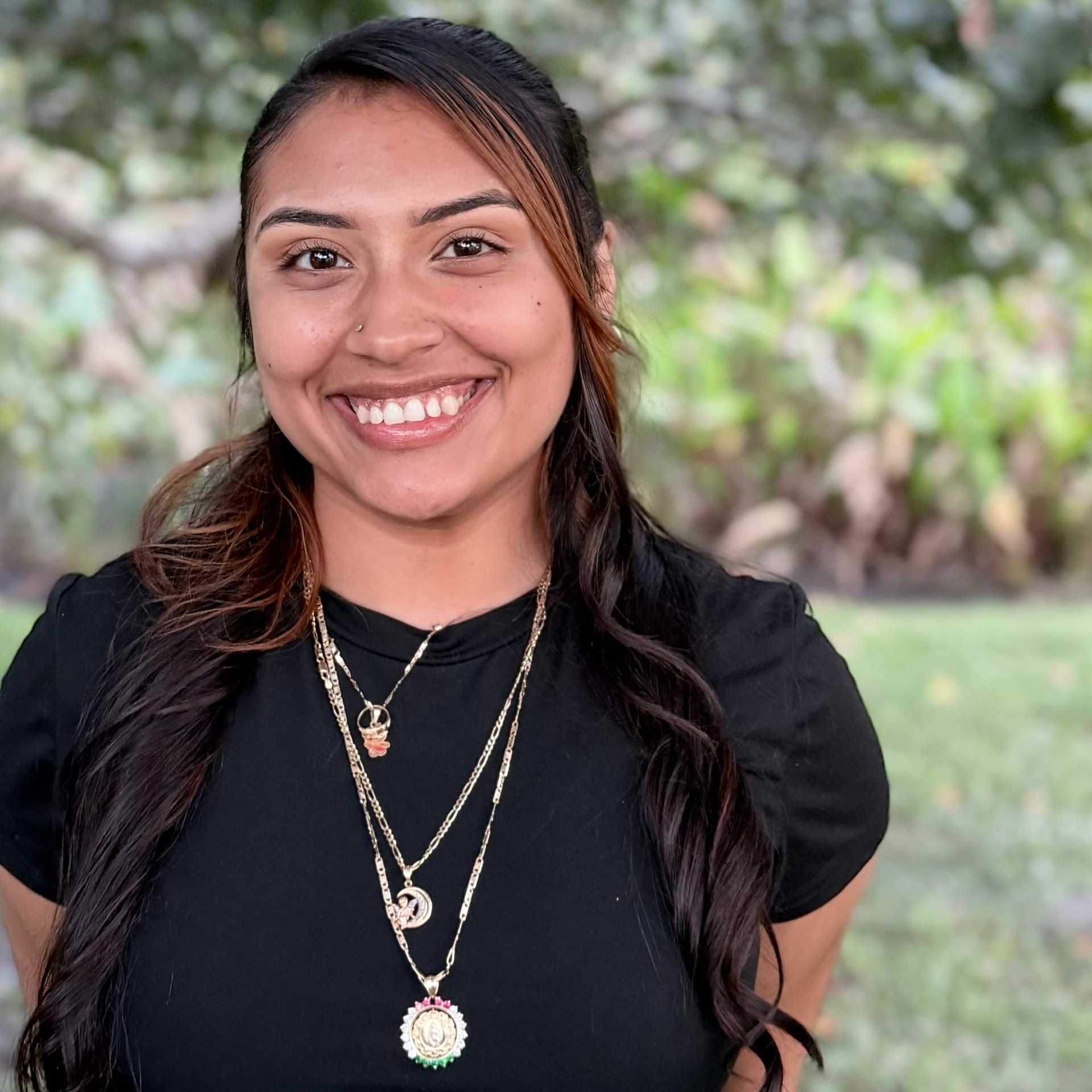 Portrait of Dayanara "Daya" Farias, a professional stylist at Grey and Sage Salon, showcasing their expertise and style.