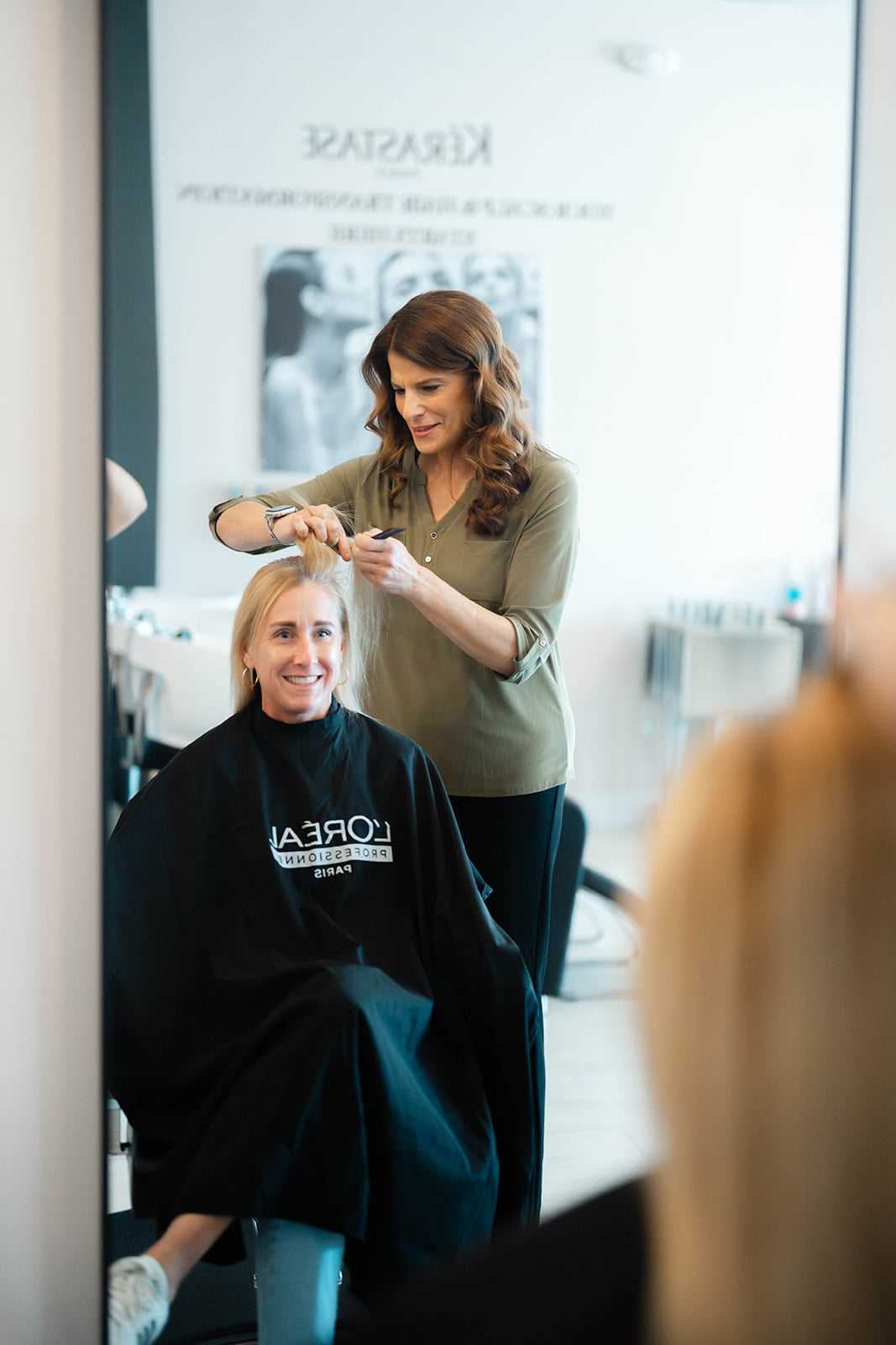 Woman receiving professional hair repair treatment for bleach-damaged blonde hair at a salon