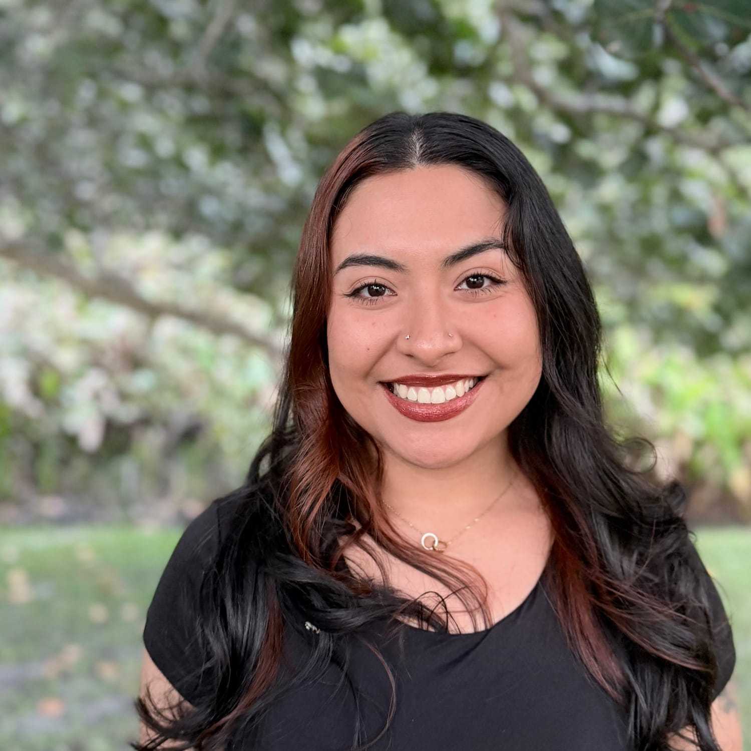 Portrait of Melanie Mejia, a professional stylist at Grey and Sage Salon, showcasing their expertise and style.