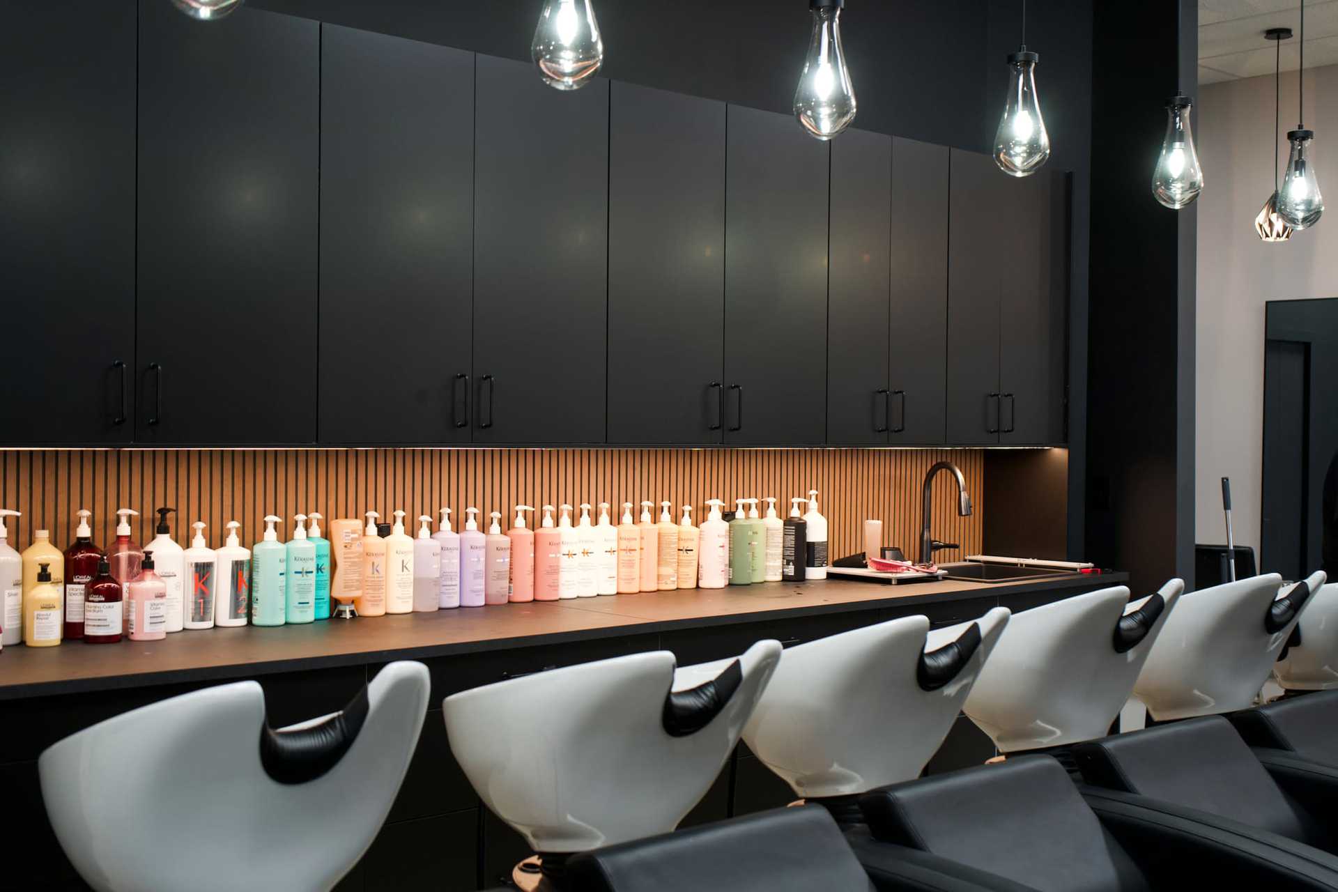 New Grey & Sage Salon treatment area in Wellington, FL with eight luxury shampoo stations