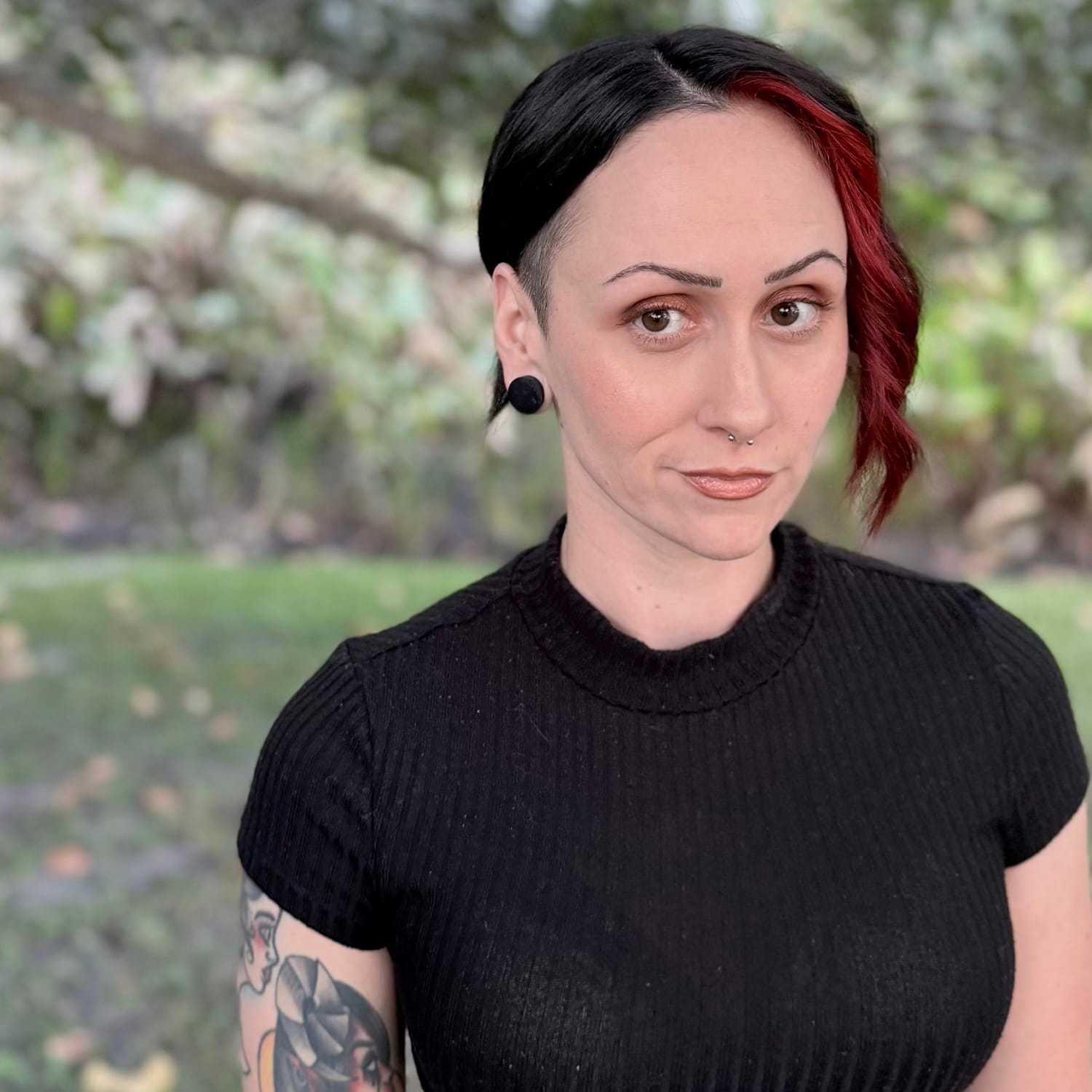 Portrait of Alyssa Guevarez, a professional stylist at Grey and Sage Salon, showcasing their expertise and style.