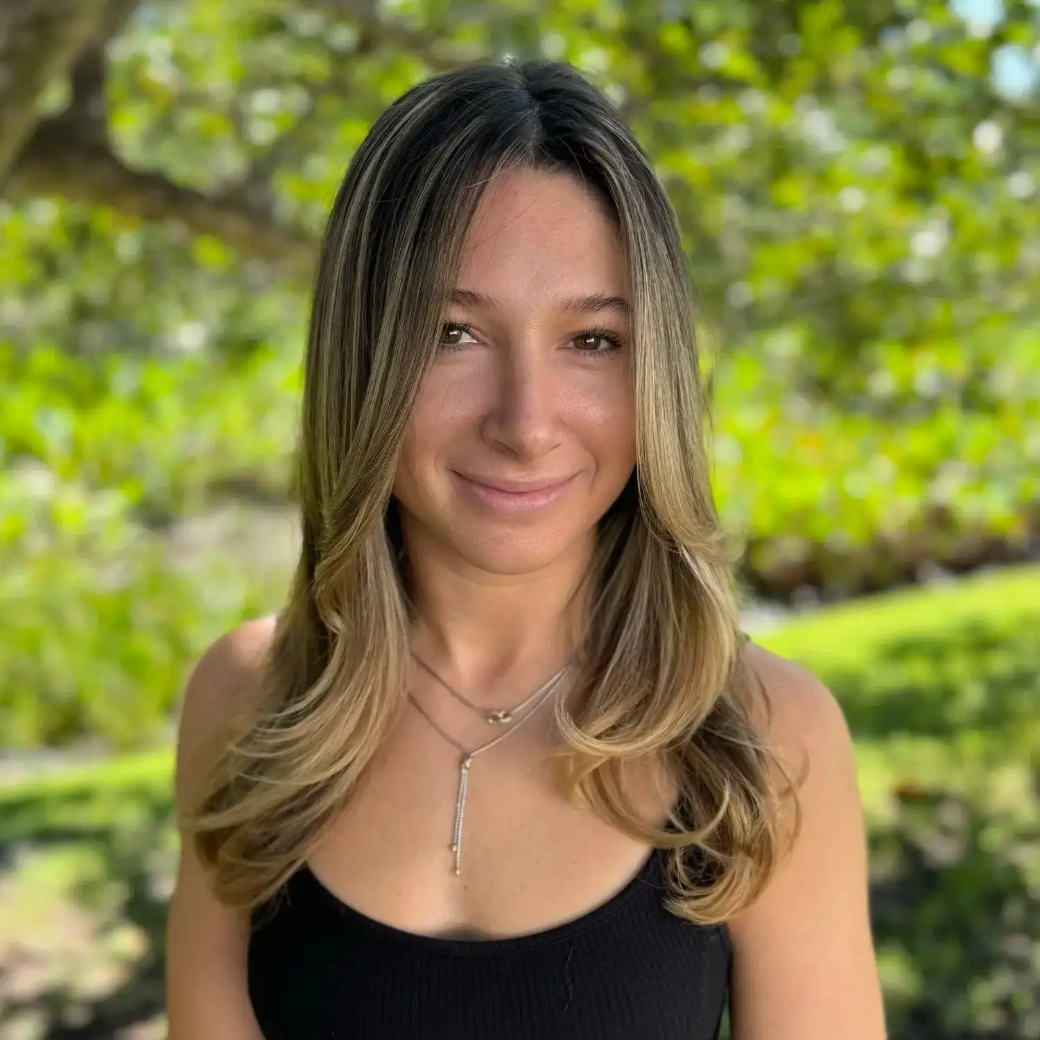 Portrait of Jocelyn Turetzky, a professional stylist at Grey and Sage Salon, showcasing their expertise and style.